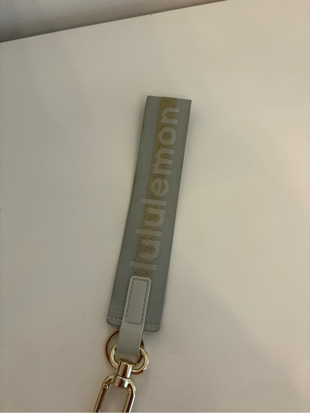 Lululemon Never Lost keychain Vapor/Gold color
